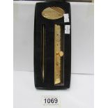 A boxed Benson & Hedges pen and rule set