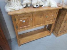 A solid pippy oak 2 door console table