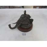 A circa 19th/20th century inkwell in the form of an elephant head with monkey musician finial