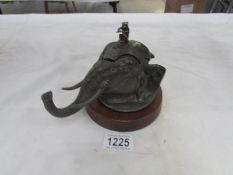 A circa 19th/20th century inkwell in the form of an elephant head with monkey musician finial