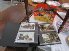 An album and box of in excess of 200 postcards including Lincolnshire, Sussex,