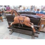 A large wooden rocking horse - ear repaired & missing tail