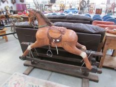 A large wooden rocking horse - ear repaired & missing tail