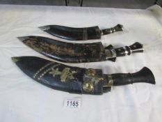 3 kukris with scabbards and skinning knives