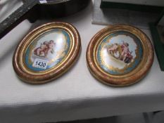 A pair of 19th century continental oval paintings on porcelain in giltwood frames