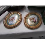 A pair of 19th century continental oval paintings on porcelain in giltwood frames