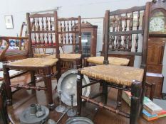 A set of 6 19th century rush seated chairs with hoof feet and spindle backs