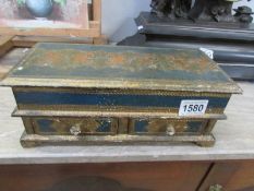 A gilded lacquered glove box with drawers