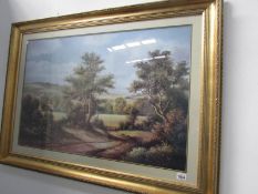 A large gilt framed woodland scene with cottage