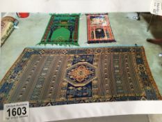 3 prayer mats in various patterns