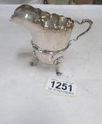 A silver cream jug,