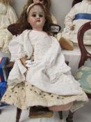 A porcelain headed doll marked 'Tiorodora?', 12 1/2M,