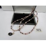A genuine pearl necklace with 14ct gold clasp and smoky quartz drop