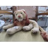 A vintage soft toy reclining lion (stitching on underside loose)