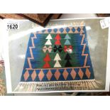 A blue, red, green and cream patterned rug,