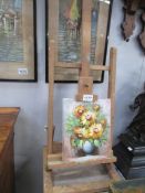 A floral oil on canvas on artist easel