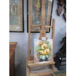 A floral oil on canvas on artist easel