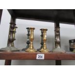 4 pairs of brass candlesticks
