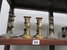 4 pairs of brass candlesticks