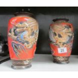 A pair of Japanese vases decorated with dragons