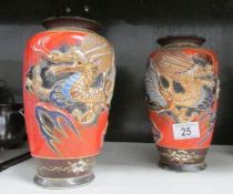 A pair of Japanese vases decorated with dragons