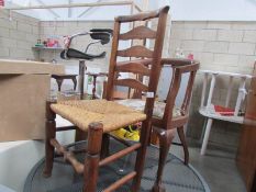 A ladder back chair and one other