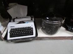 An Erika portable typewriter and an enamel stew pan