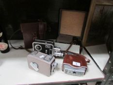 A mini slide projector kit, a leather cased cine camera,