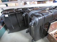 A pair of modern hard case suit cases