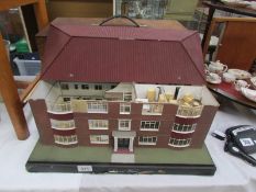 A model of a 'Halls of Residence' with fitted furniture and cover beds