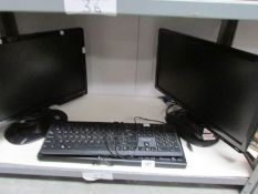 2 computer monitors and 2 key boards