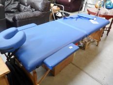 A folding massage table with carry bag