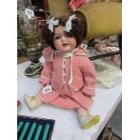 A 19th century Armand Marseille porcelain headed doll with open mouth