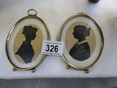 A pair of oval framed silhouettes