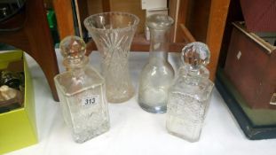 3 glass decanters and a vase
