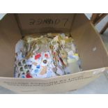 A large box of loose postage stamps