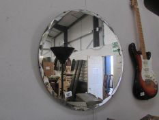 A circular bevel edged mirror