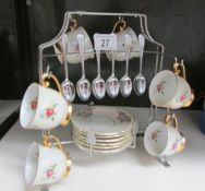 A retro coffee set with spoons and on chrome stand