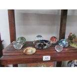 A quantity of glass paperweights and a glass bowl