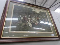 A framed and glazed print entitled Village Holiday