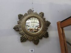 A starburst mirror and a figural table lamp