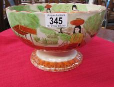 A hand painted oriental bowl featuring figures,