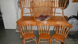 A pine dining table and 6 chairs