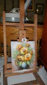 An artist's easel with floral still life oil on canvas