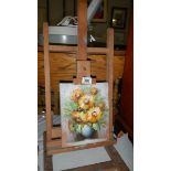An artist's easel with floral still life oil on canvas