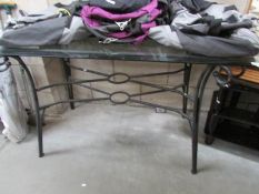 A metal table with glass top