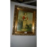 A gilt framed picture of a boy with puppy