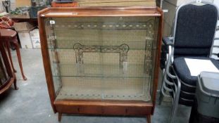 A display cabinet with sliding glass doors