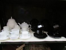 A white Wedgwood tea set and a black tea set