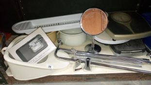 A shelf of bathroom items including ceramic bed pan